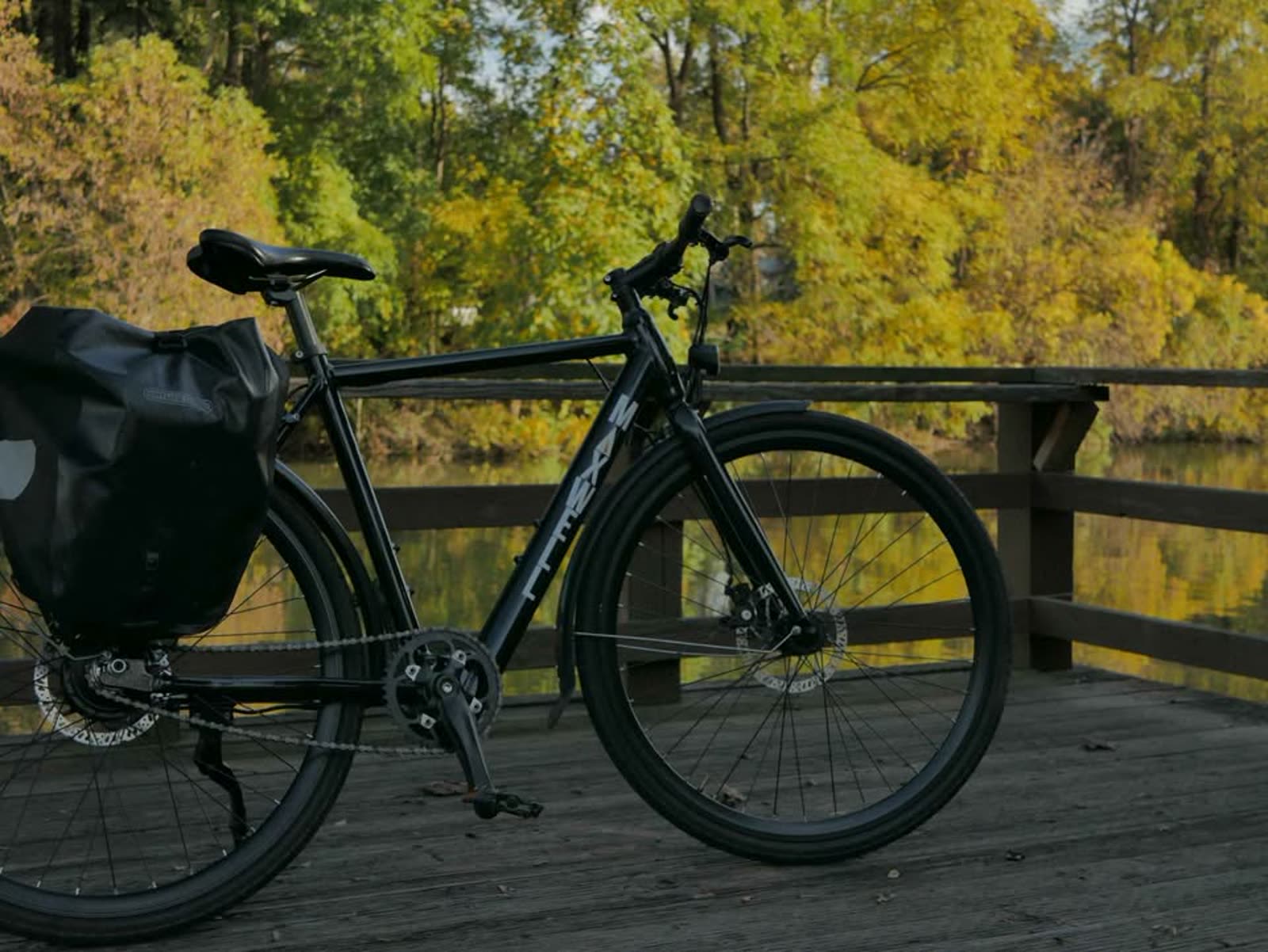 Maxwell Stoic e-bike on a wooden bridge over the water